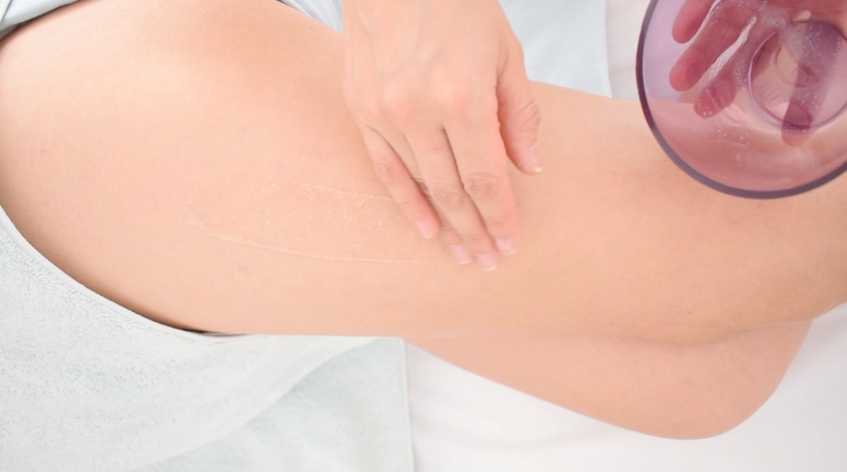 Preparación de la piel con exfoliante antes del tratamiento anticelulitis.